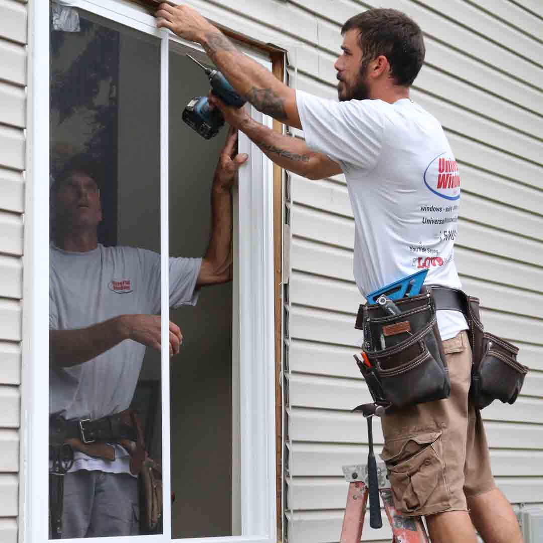 installer drilling in window