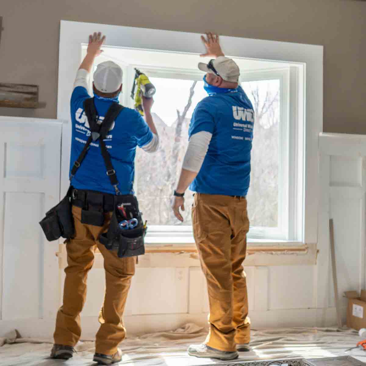 Window installers replacing a bay window