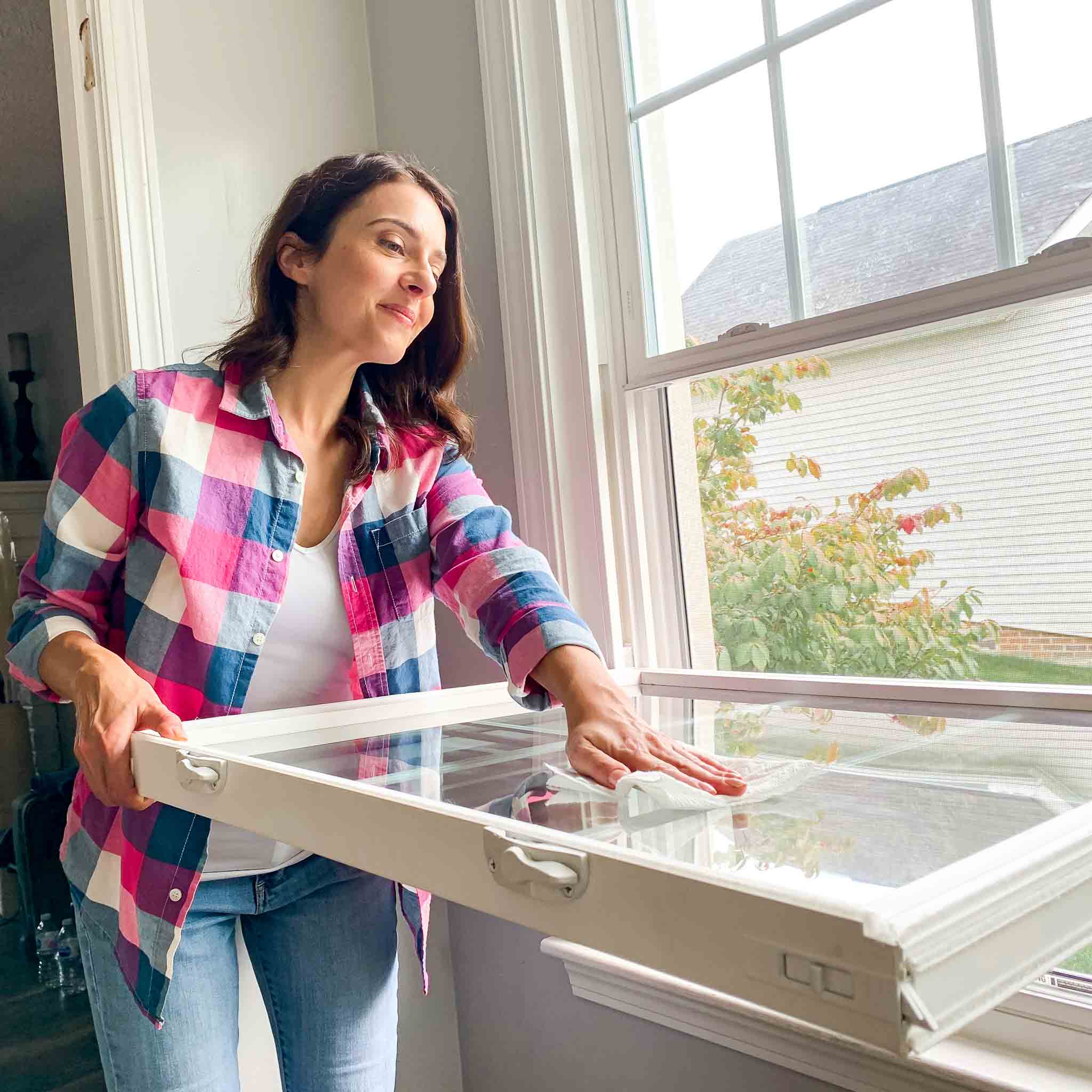 Woman cleaning window