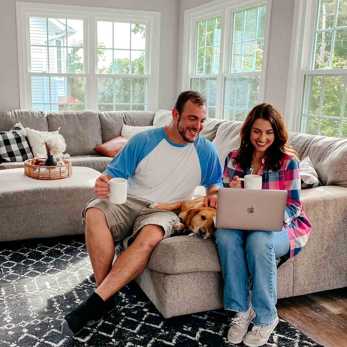 A couple sitting and looking at a laptop