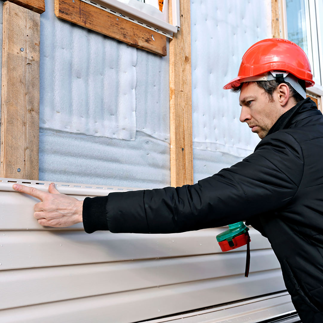 man installing vinyl siding