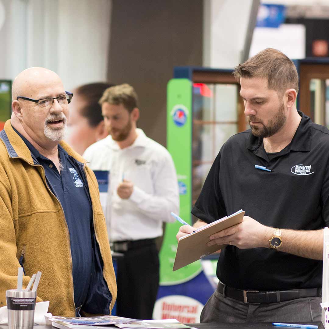 UWD marketer explaining purchase process to customer at Home and Garden Show