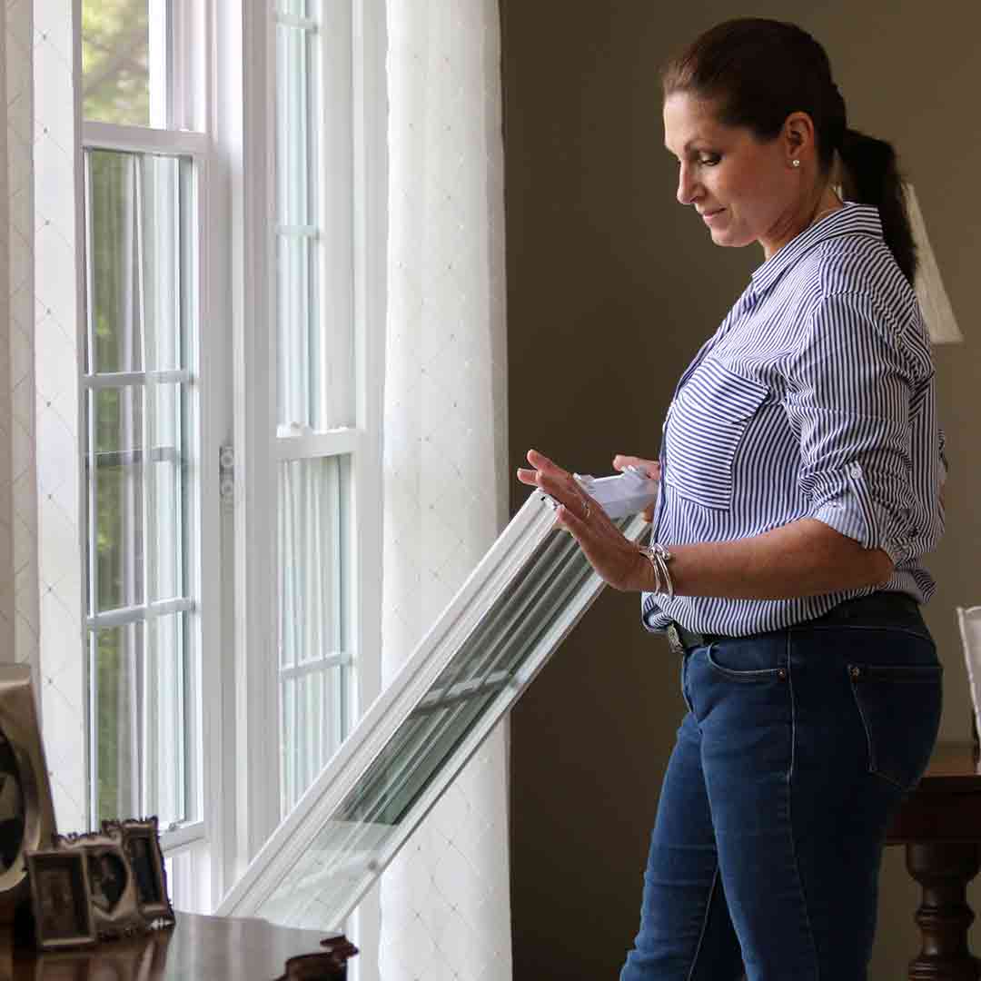 woman tilting-in a double hung window